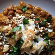 Chilaquiles with crema, cotija cheese and cilantro