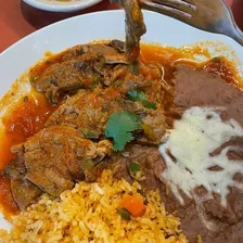 Pork ribs in salsa, with rice and refried beans