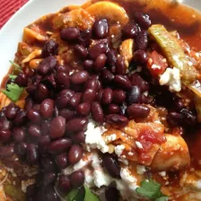 Black beans with tortilla chips and queso fresco