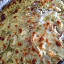 A baked pizza built on salsa verde instead of tomato