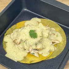 Chicken guisado in salsa verde with corn and vegetables, served on a plate